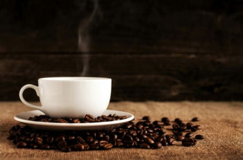 white-ceramic-mug-and-saucer-with-coffee-beans-on-brown-textile.jpg white ceramic mug and saucer with coffee beans on brown textile