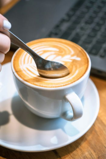 spoon-mixing-beautiful-latte-art-in-a-cup-.jpg Spoon mixing beautiful latte art in a cup.